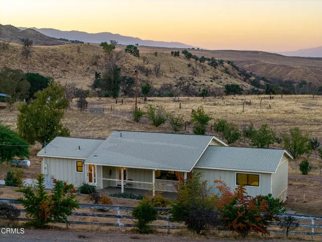 a aerial view of a house next to a yard