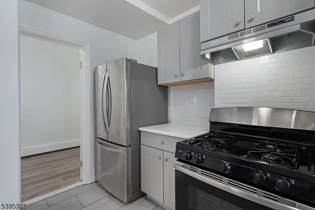 a kitchen with a stove and a refrigerator