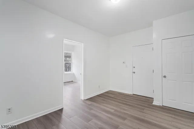 an empty room with wooden floor