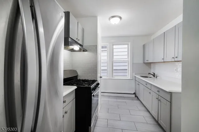 a kitchen with a sink a refrigerator and a stove