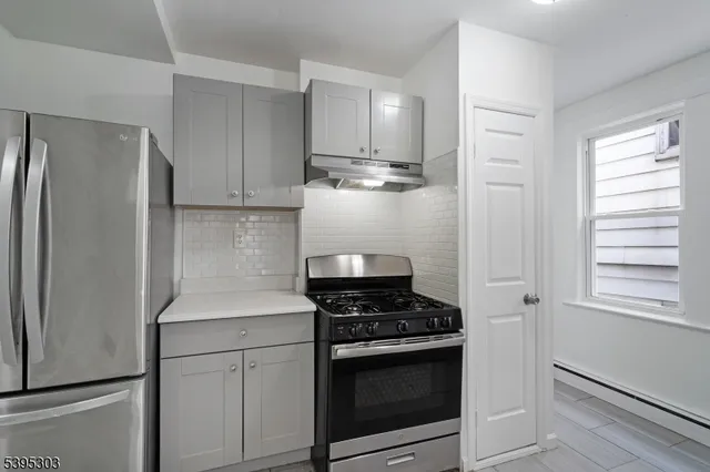 a kitchen with cabinets and stainless steel appliances
