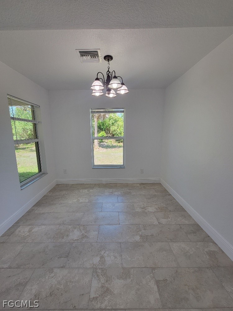 355 Paddock Street Lehigh Acres, FL 33974 - Photo 11 of 29 an empty room with windows