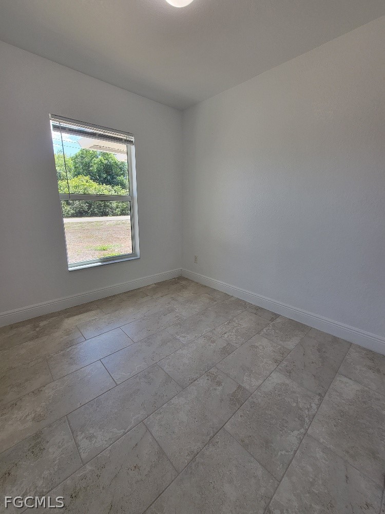 355 Paddock Street Lehigh Acres, FL 33974 - Photo 12 of 29 an empty room with a window
