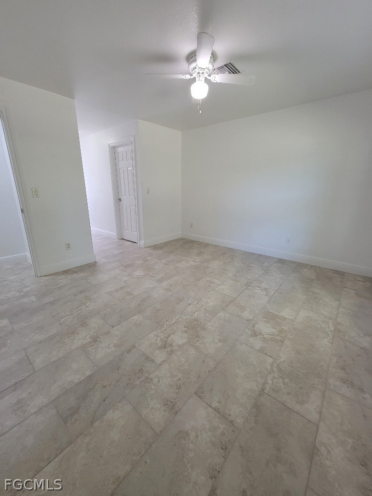 355 Paddock Street Lehigh Acres, FL 33974 - Photo 15 of 29 a view of empty room with a ceiling fan