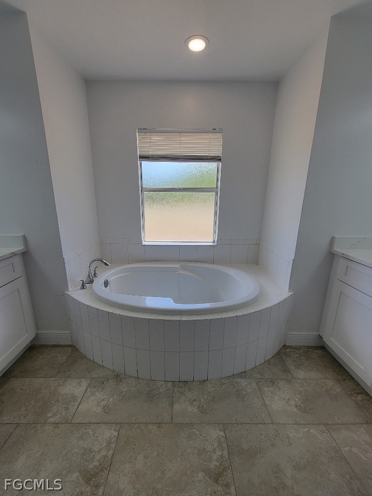 355 Paddock Street Lehigh Acres, FL 33974 - Photo 19 of 29 a bathroom with a tub and a window