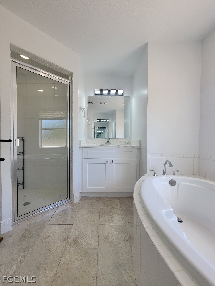355 Paddock Street Lehigh Acres, FL 33974 - Photo 20 of 29 a bathroom with a bathtub and a sink