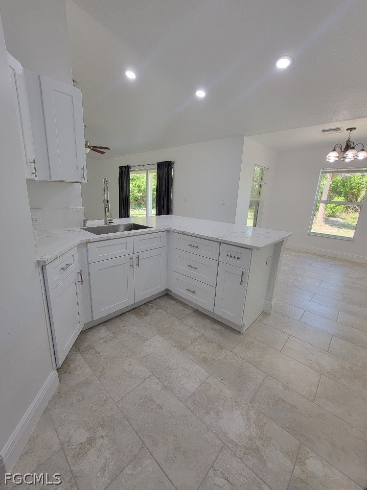 355 Paddock Street Lehigh Acres, FL 33974 - Photo 9 of 29 a kitchen with cabinets and window