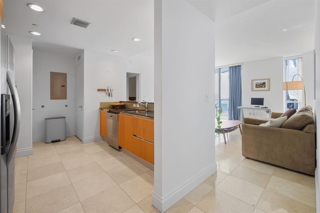 1050 Brickell Avenue, Unit 2302 Miami, FL 33131 - Photo 22 of 50 a view of a kitchen with furniture and an empty room