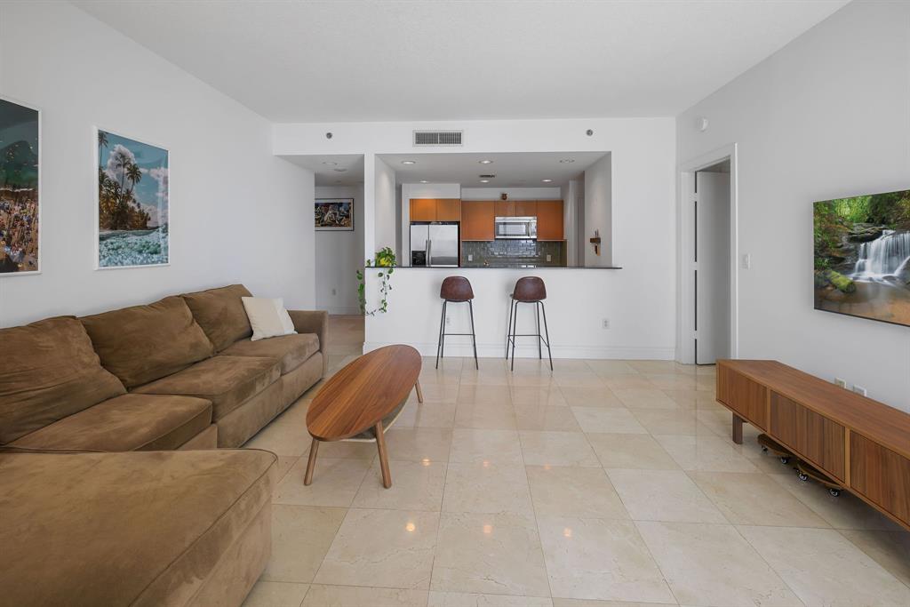 1050 Brickell Avenue, Unit 2302 Miami, FL 33131 - Photo 29 of 50 a living room with furniture and a wooden floor