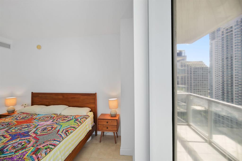 1050 Brickell Avenue, Unit 2302 Miami, FL 33131 - Photo 33 of 50 a bedroom with a bed and next to a window