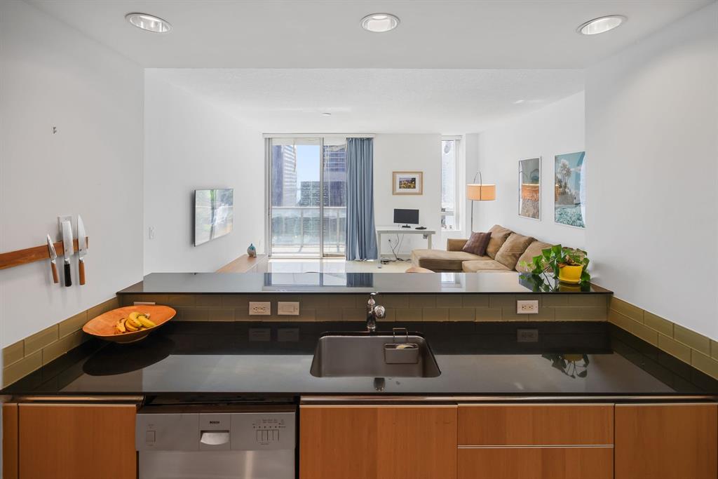 1050 Brickell Avenue, Unit 2302 Miami, FL 33131 - Photo 5 of 50 a kitchen with a sink cabinets and window