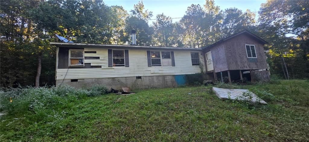 401 Towaliga Trail Forsyth, GA 31029 - Photo 22 of 29 a backyard of a house with wooden fence and large trees
