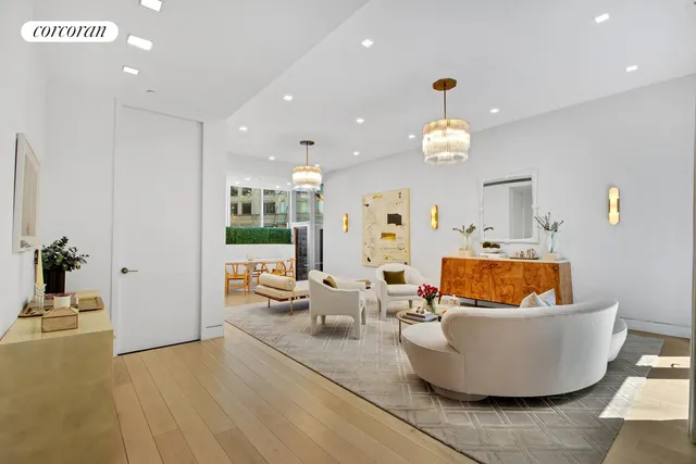 a living room with furniture and a chandelier