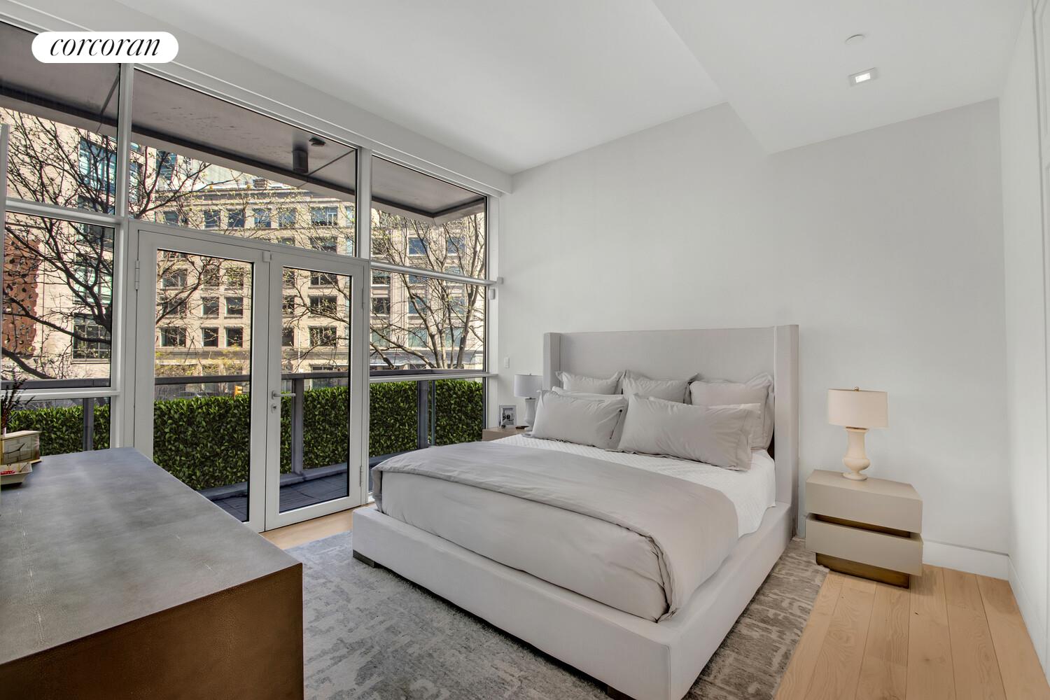 471 Washington Street, Unit THC Manhattan, NY 10013 - Photo 11 of 15 a bedroom with a large bed and a large window