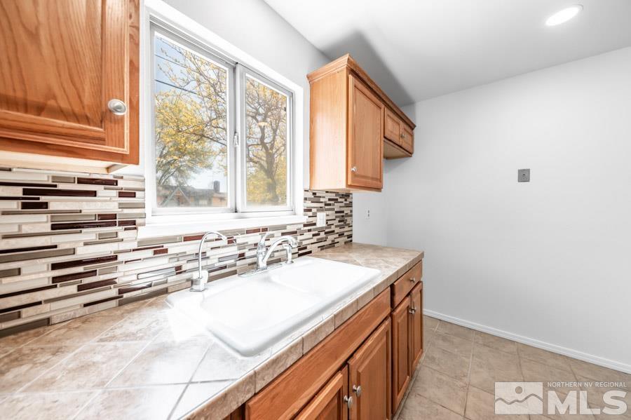 2441 Baxter Way Sparks, NV 89431 - Photo 11 of 25 a bathroom with a sink and a window