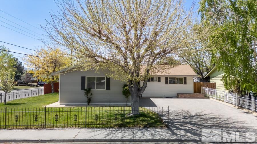 2441 Baxter Way Sparks, NV 89431 - Photo 2 of 25 a front view of a house with a garden