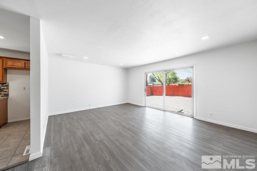 2441 Baxter Way Sparks, NV 89431 - Photo 4 of 25 an empty room with wooden floor and window