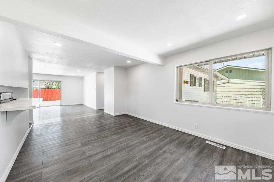 2441 Baxter Way Sparks, NV 89431 - Photo 7 of 25 a view of an empty room with a window and wooden floor