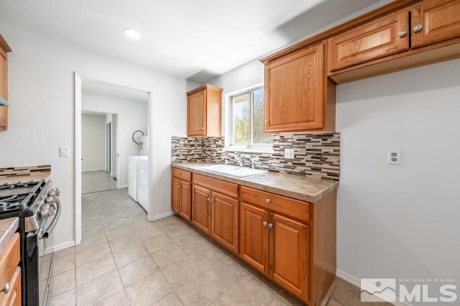 2441 Baxter Way Sparks, NV 89431 - Photo 9 of 25 a spacious bathroom with a granite countertop sink a mirror and a bathtub