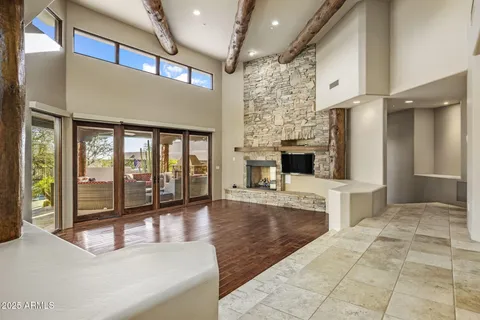 a living room with furniture and large windows
