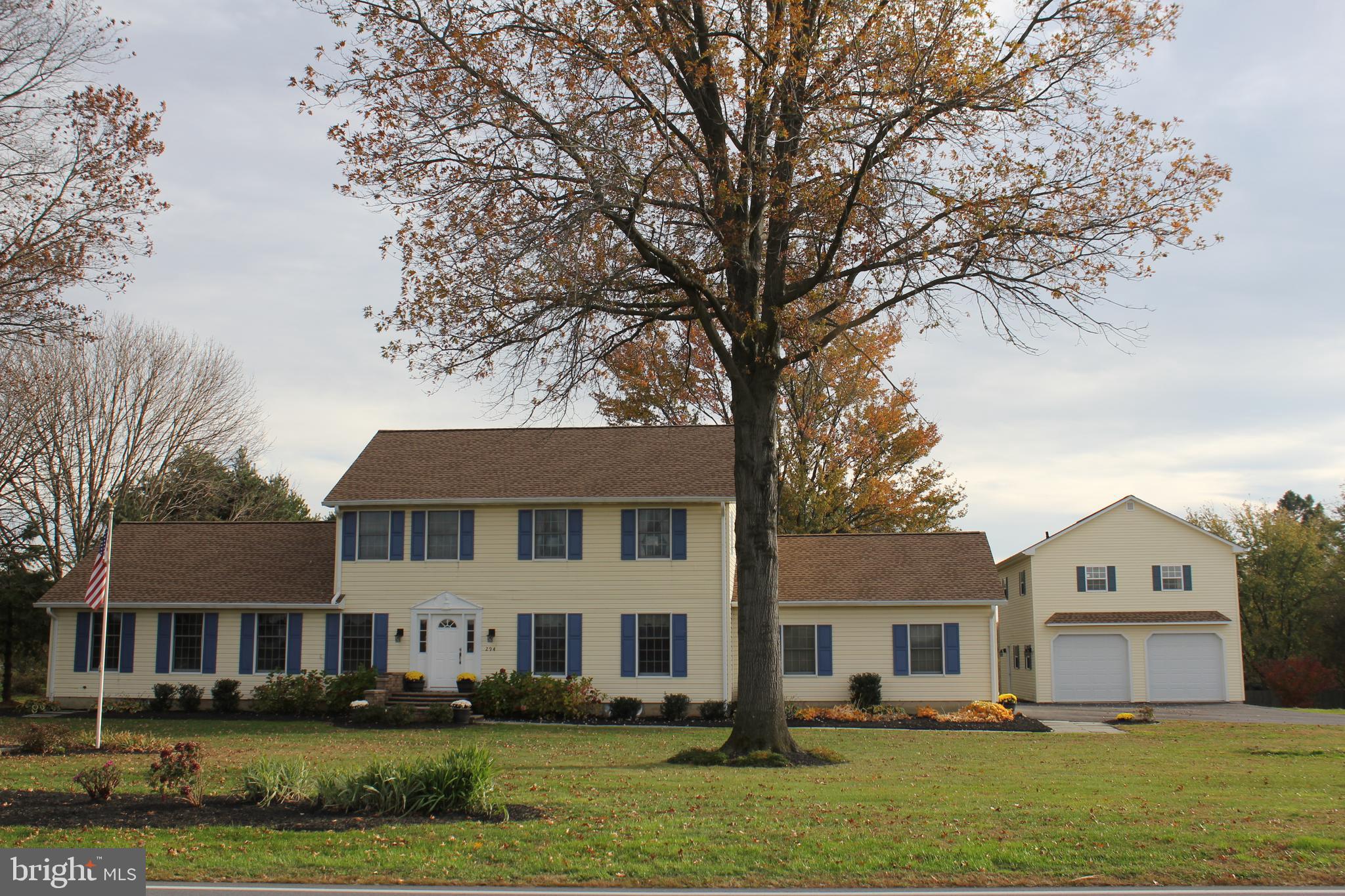 a front view of a residential apartment building with a yard
