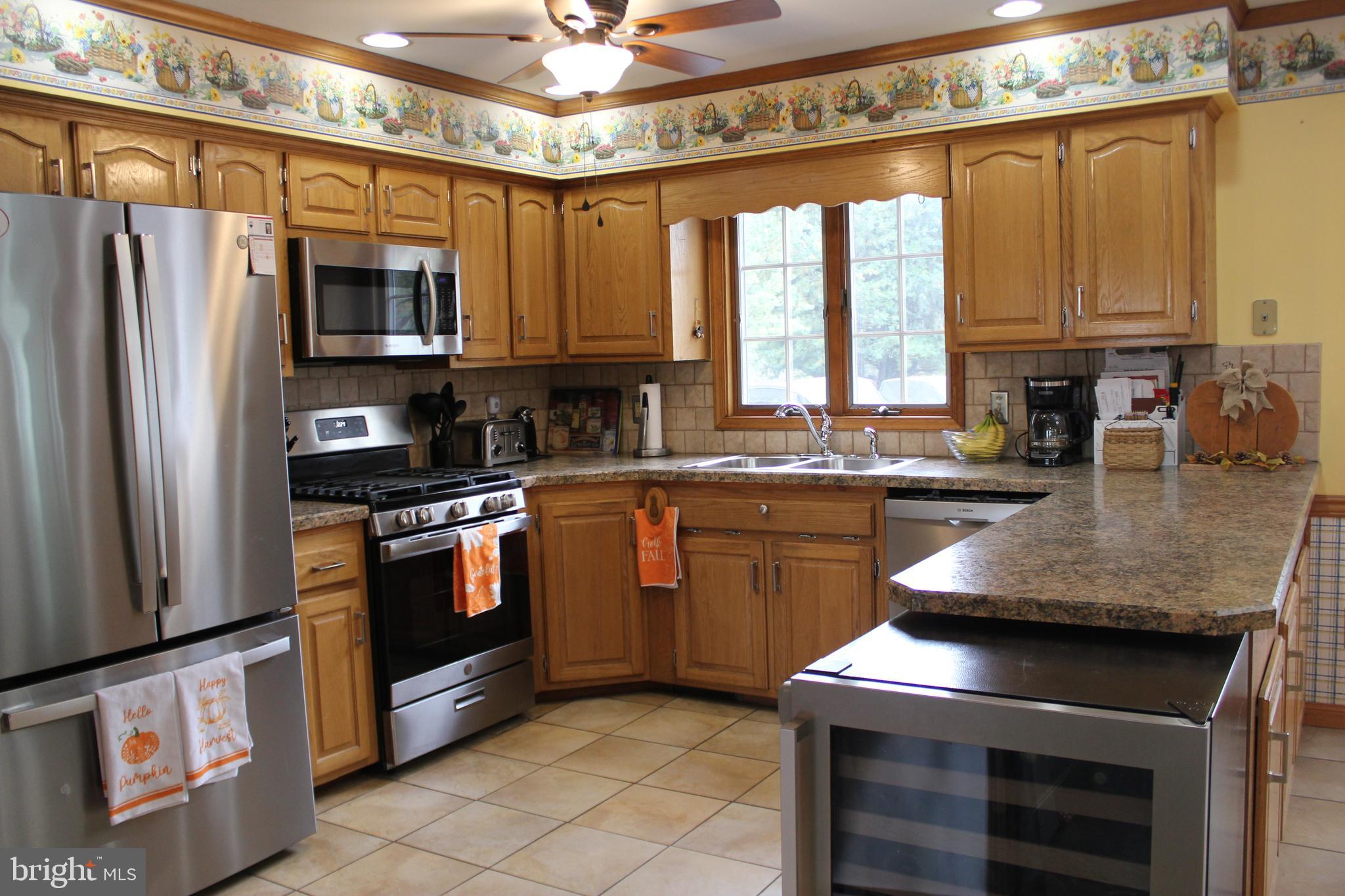 294 Starr Road Landenberg, PA 19350 - Photo 13 of 68 a kitchen with stainless steel appliances granite countertop a stove a sink and a refrigerator