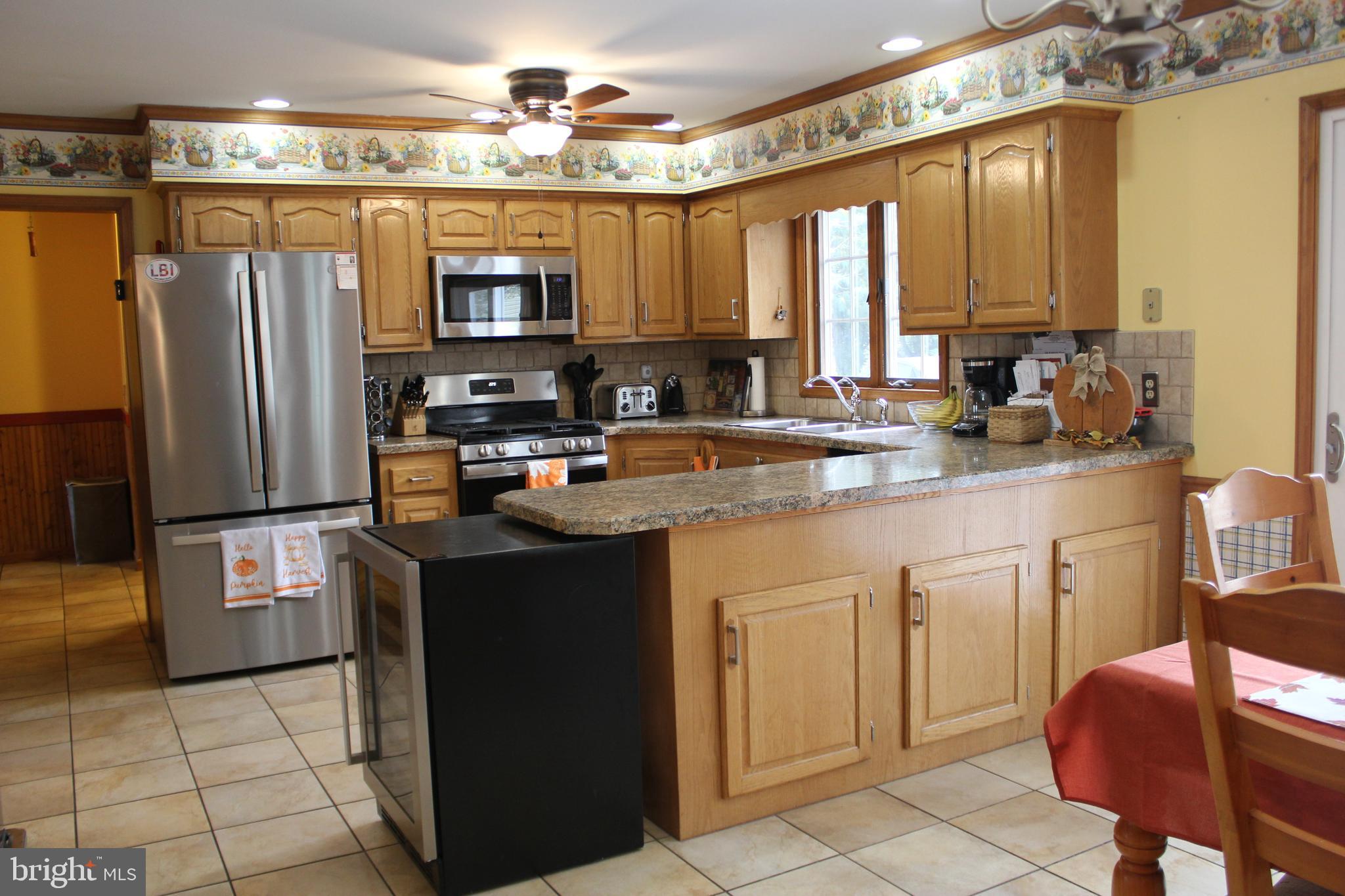 294 Starr Road Landenberg, PA 19350 - Photo 14 of 68 a kitchen with stainless steel appliances granite countertop a refrigerator and a stove top oven