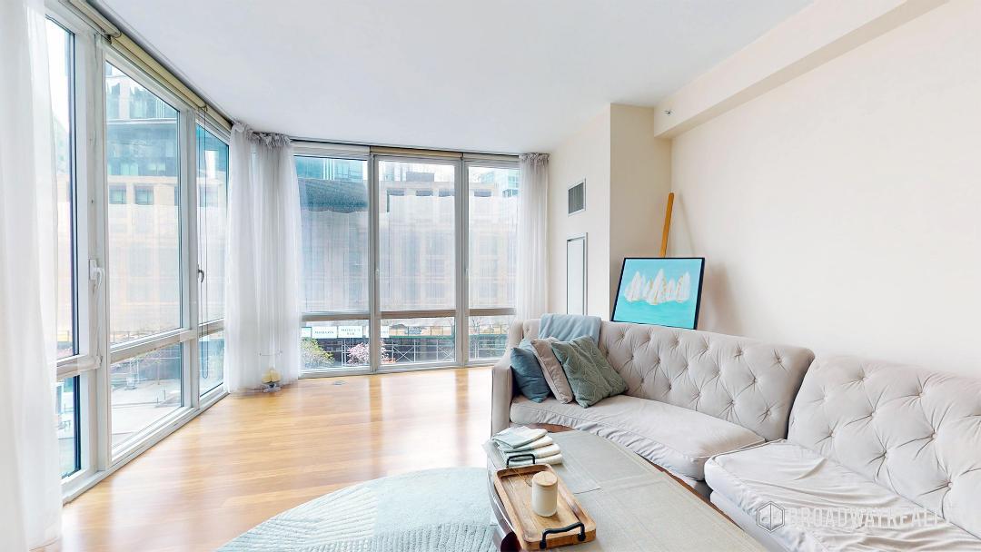 10 West End Avenue, Unit 4D Manhattan, NY 10023 - Photo 1 of 8 a living room with furniture and a large window