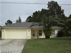 669 Homestead Road South, Unit 71 Lehigh Acres, FL 33974 - Photo 1 of 21 a front view of a house with a garden