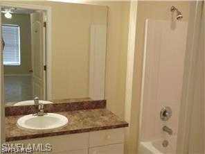 669 Homestead Road South, Unit 71 Lehigh Acres, FL 33974 - Photo 17 of 21 a bathroom with a sink and a mirror