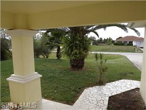 669 Homestead Road South, Unit 71 Lehigh Acres, FL 33974 - Photo 19 of 21 a view of a garden from a lake