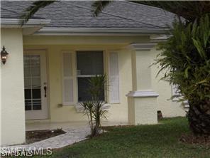 669 Homestead Road South, Unit 71 Lehigh Acres, FL 33974 - Photo 2 of 21 a front view of a house with garden