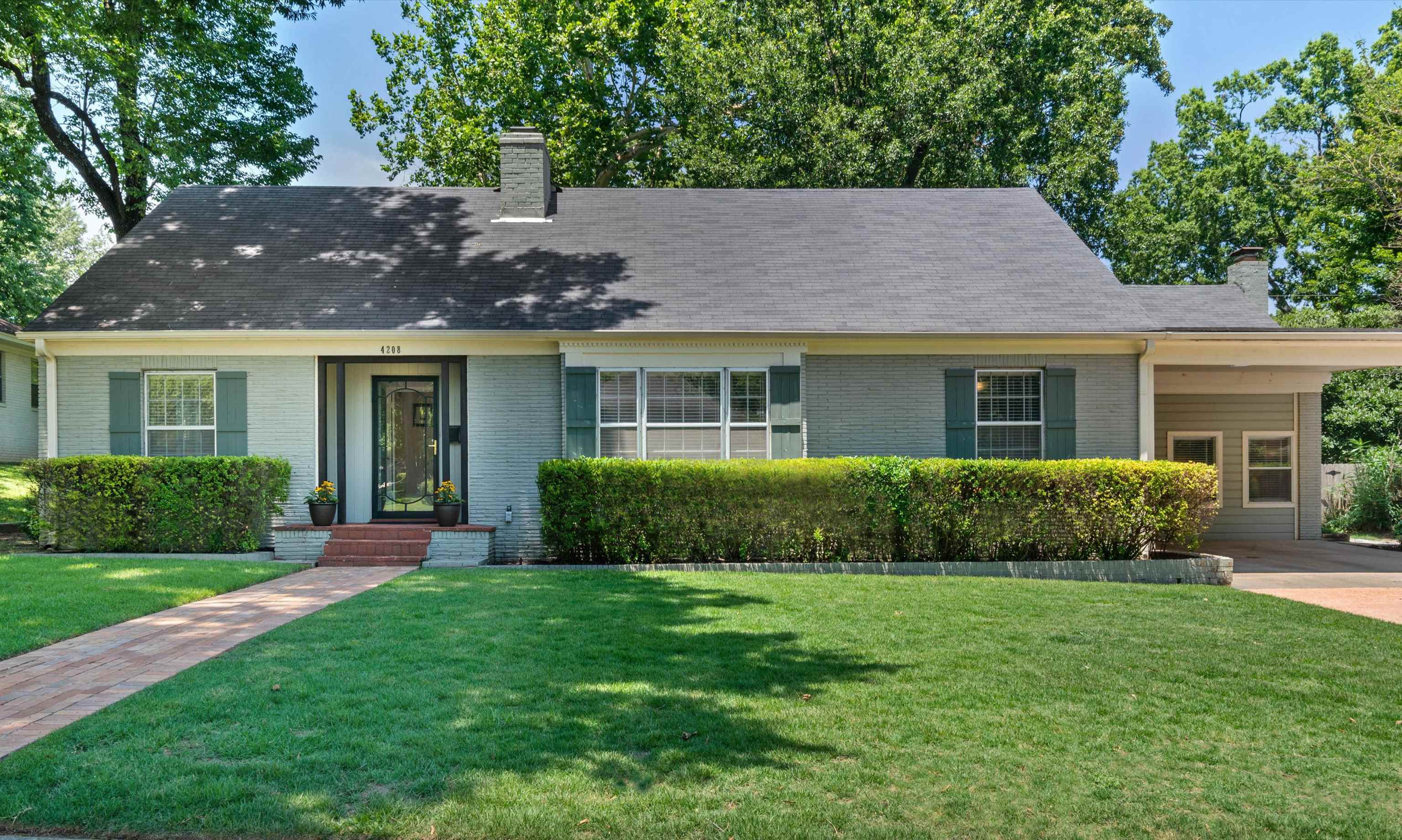4208 Chickasaw Road Memphis, TN 38117 - Photo 1 of 25 a view of a house with a yard and potted plants