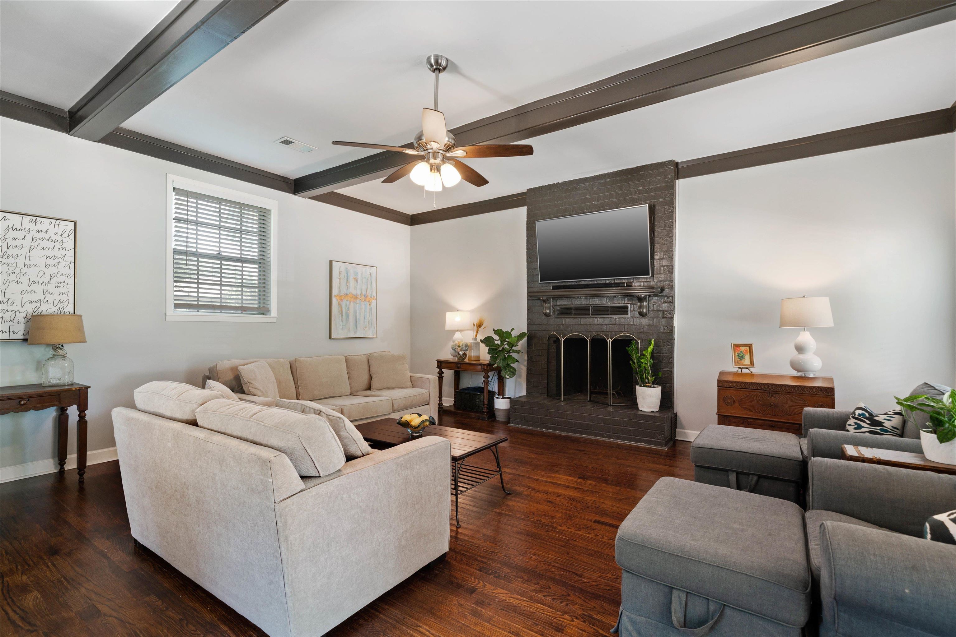 4208 Chickasaw Road Memphis, TN 38117 - Photo 12 of 25 a living room with furniture a fireplace and a flat screen tv