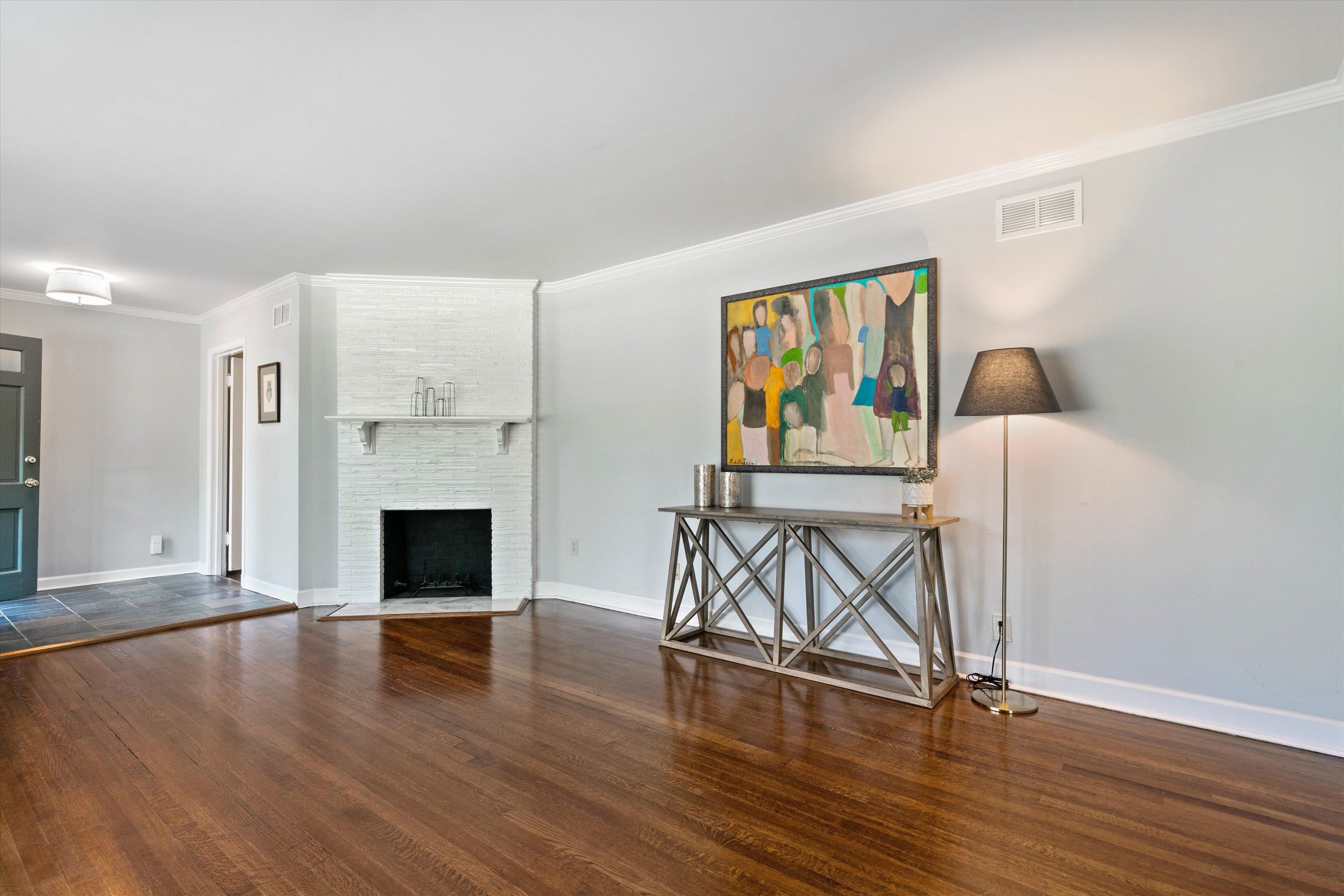 4208 Chickasaw Road Memphis, TN 38117 - Photo 5 of 25 a view of an empty room with wooden floor and a fireplace