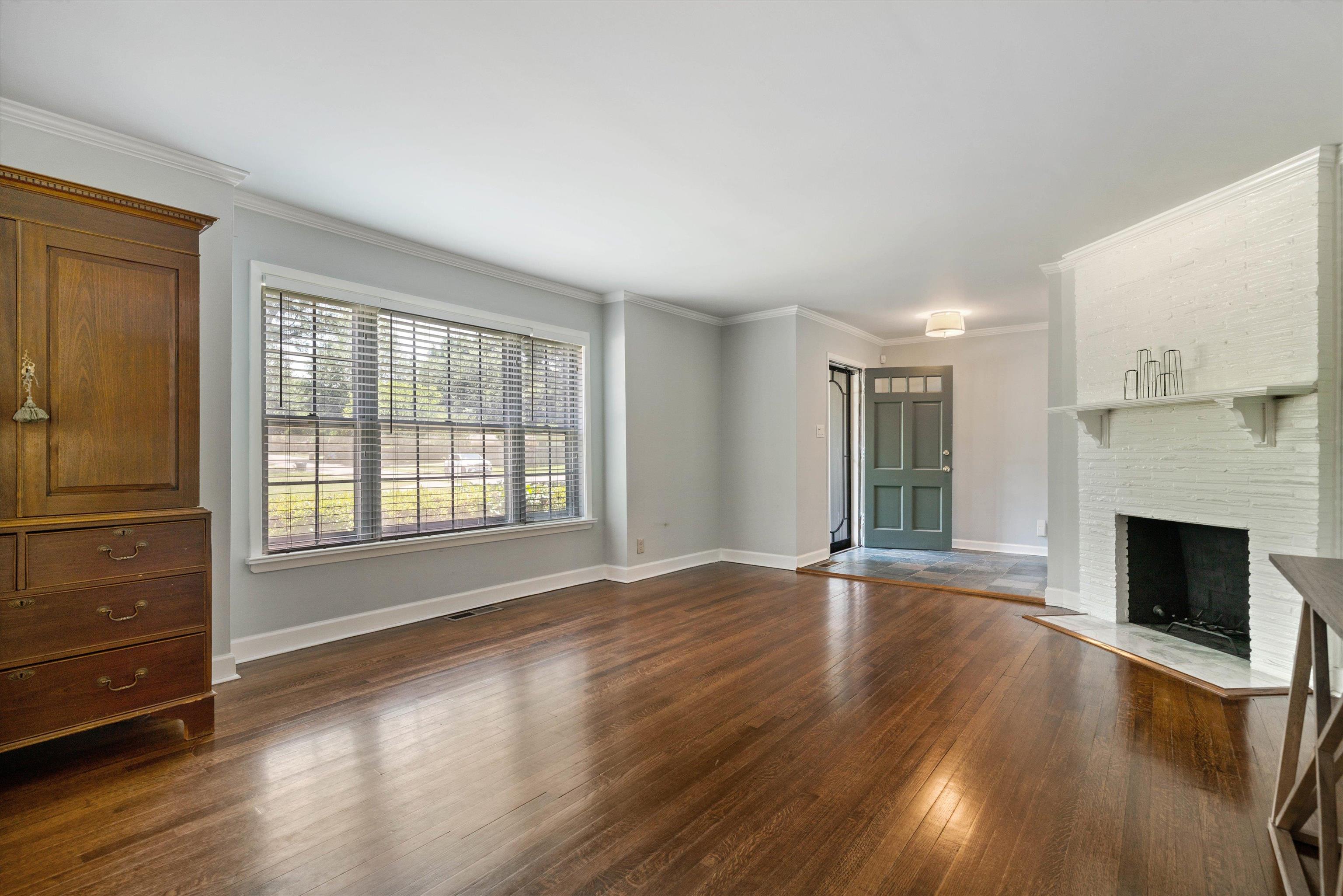 4208 Chickasaw Road Memphis, TN 38117 - Photo 6 of 25 wooden floor fireplace and windows in an empty room