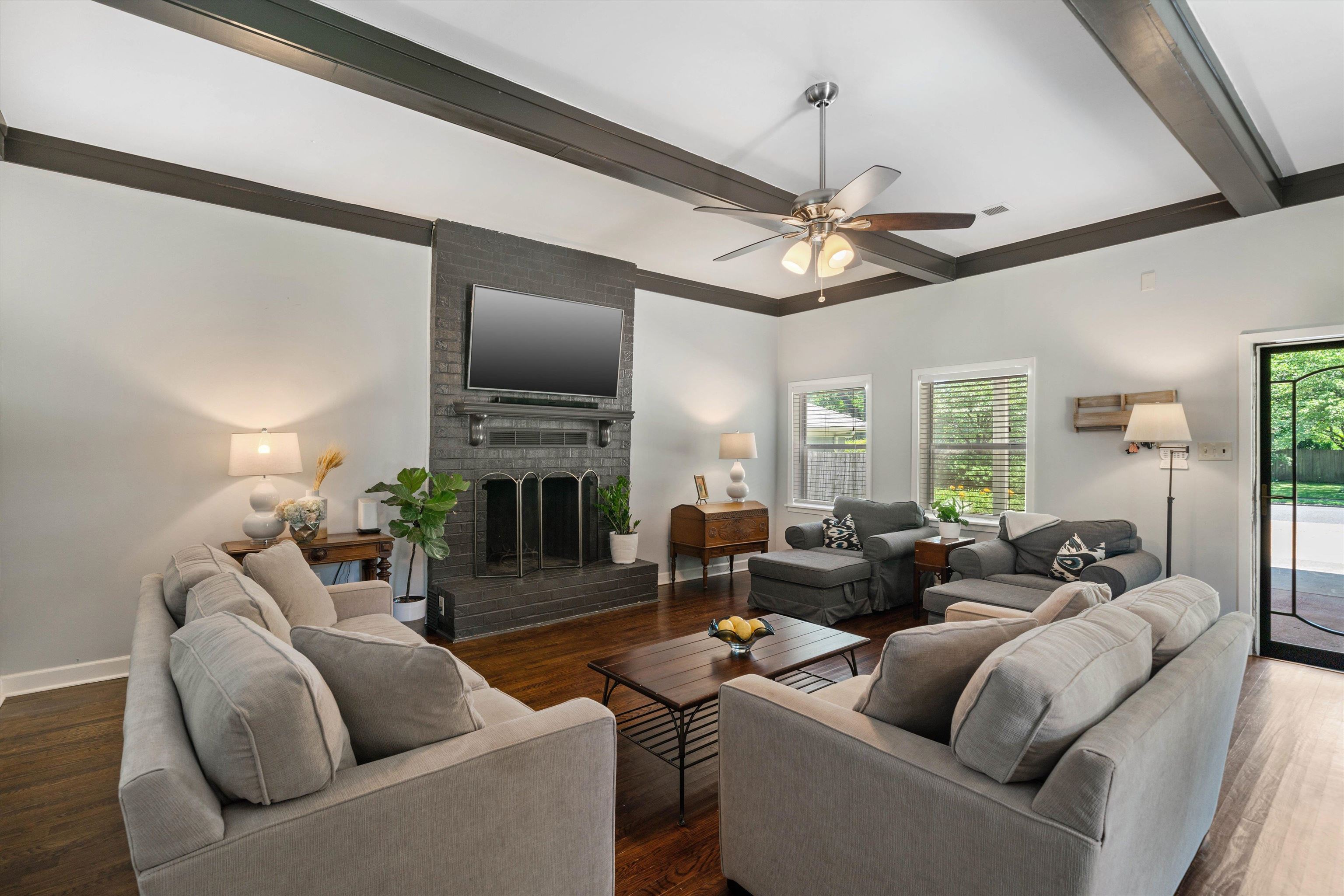 4208 Chickasaw Road Memphis, TN 38117 - Photo 10 of 25 a living room with furniture a fireplace and a chandelier