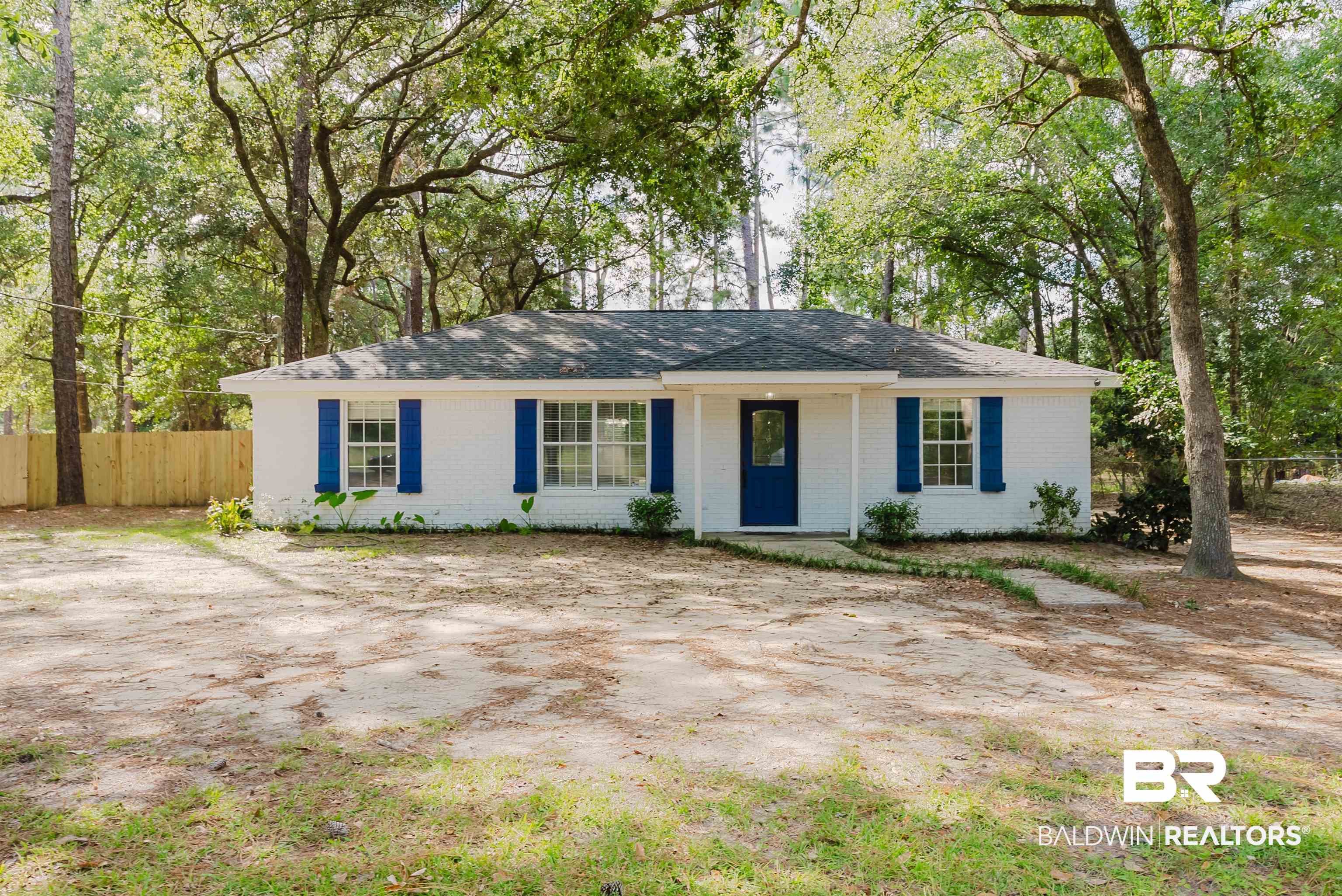 14185 Jackson Lane Foley, AL 36535 - Photo 1 of 16 Ranch-style house featuring brick siding, view of scattered trees, and roof with shingles
