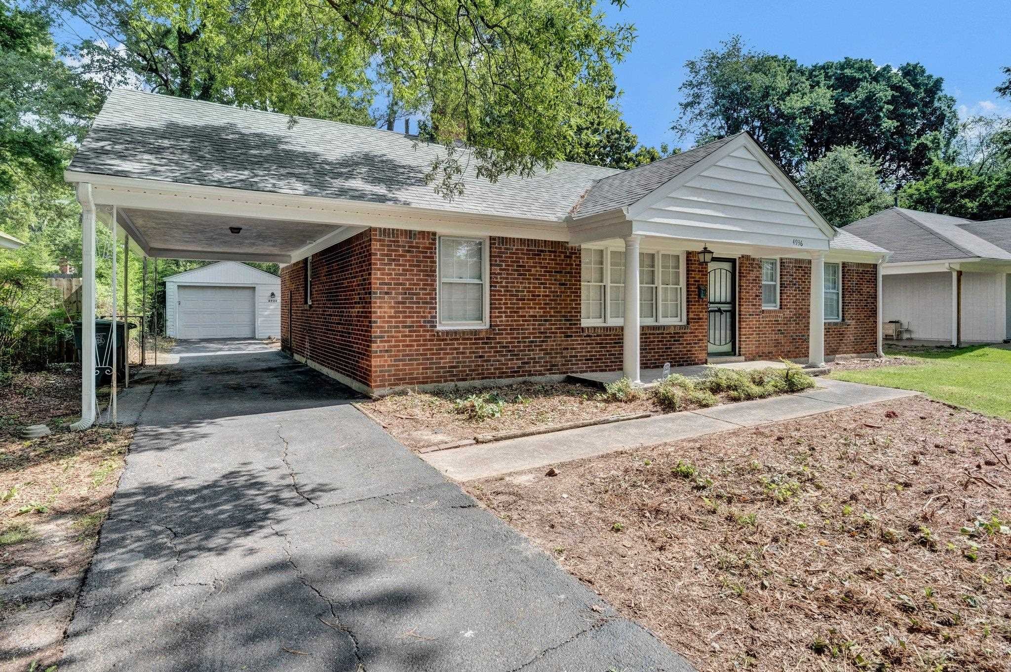 4936 Kaye Road Memphis, TN 38117 - Photo 4 of 32 a front view of a house with a yard and garage