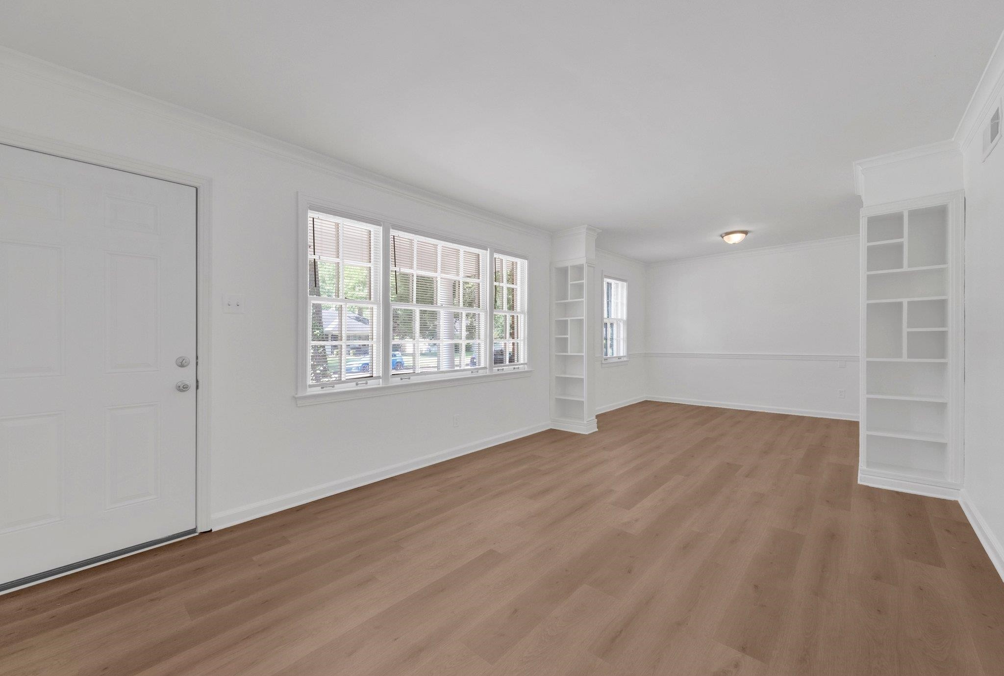 4936 Kaye Road Memphis, TN 38117 - Photo 9 of 32 a view of an empty room with wooden floor and a window