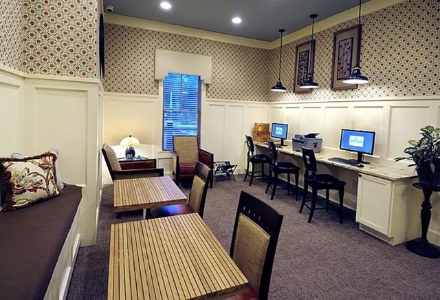 a living room with furniture a rug and kitchen view