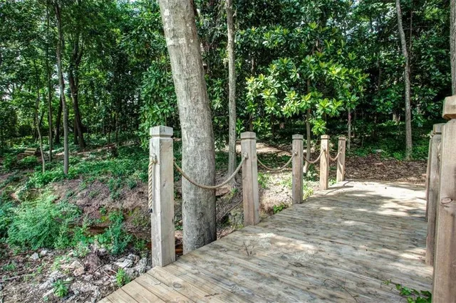 a backyard of a house with lots of green space and fountain