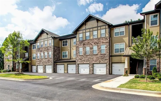 a front view of a residential apartment building with a yard