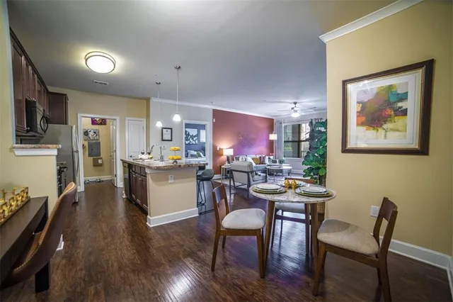 a view of a dining room with furniture and wooden floor