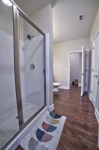 a bathroom with a shower and a mirror