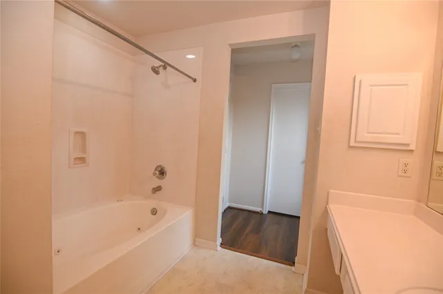 a bathroom with a bathtub and a shower