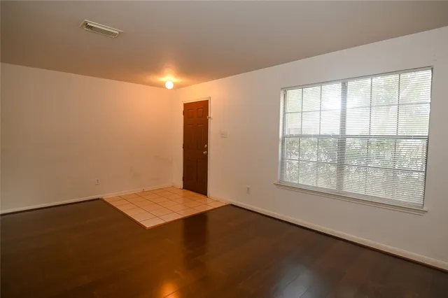 an empty room with a empty space and a window