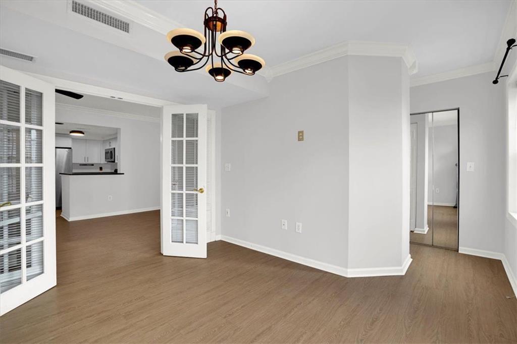 199 14th Street Northeast, Unit 2308 Atlanta, GA 30309 - Photo 14 of 35 a view of an empty room with wooden floor and a ceiling fan