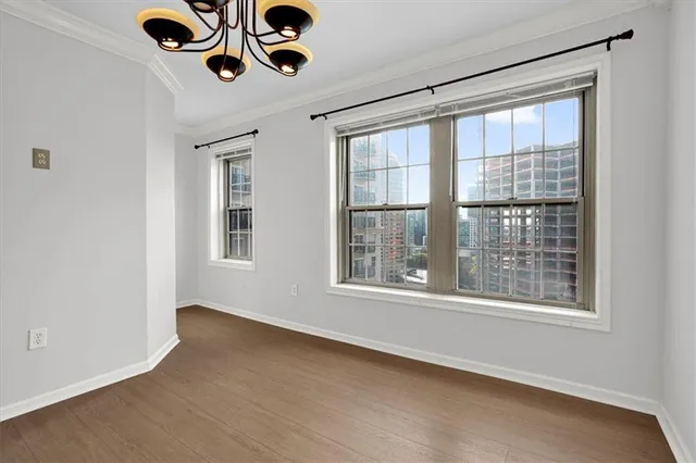 an empty room with a ceiling fan and window