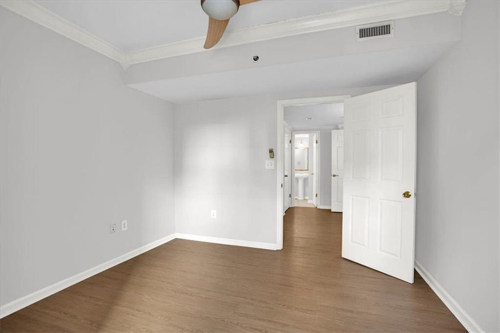 199 14th Street Northeast, Unit 2308 Atlanta, GA 30309 - Photo 19 of 35 a view of an empty room with wooden floor and windows